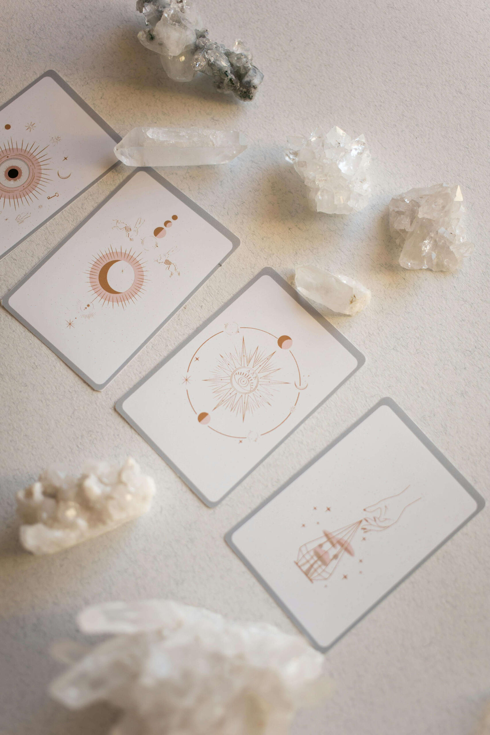 Crystal healing magic This is a photo of some clear quartz crystals alongside some oracle cards